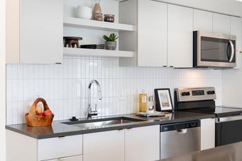 Henley Place Apartments in Milwaukie, Oregon Model Kitchen with Tile Backsplash
